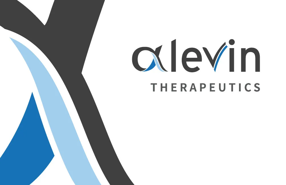 The front of the business card: a large cropped alpha in charcoal and blues beside the logo
