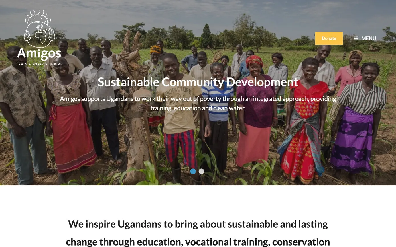 amigos.org.uk in 2023: the Amigos logo over a photo of a community group standing in a field, with “Sustainable Community Development” and a yellow Donate button