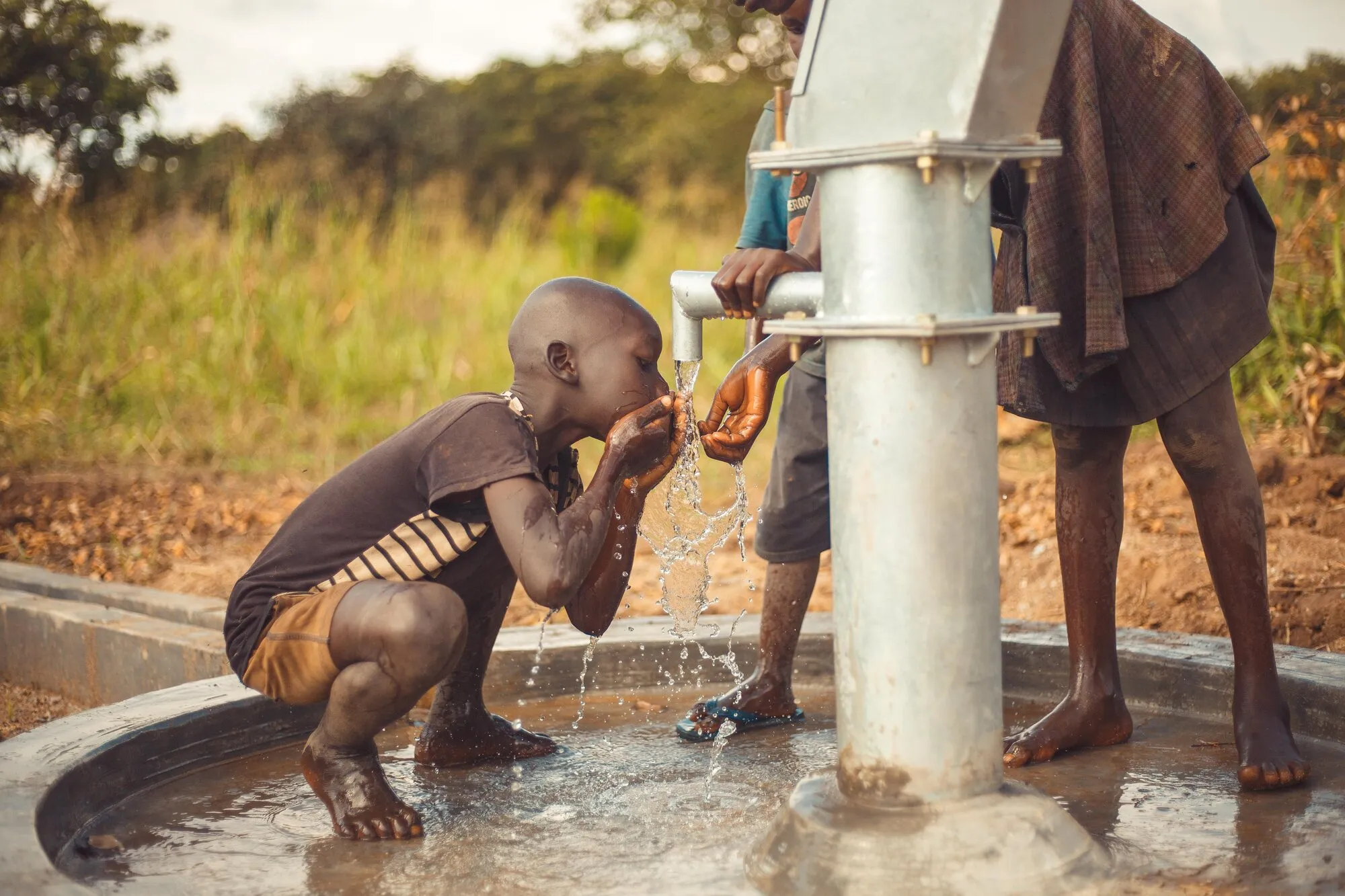 A child drinking from the tap of a new borehole