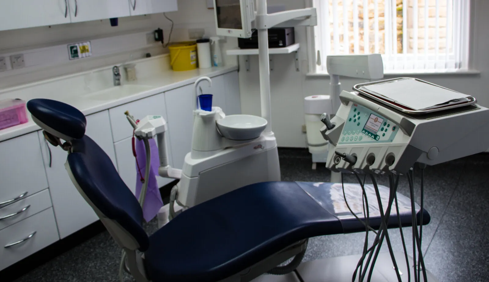 A surgery at Diamond Court: a navy dental chair beside its instrument unit, from our 2013 photo shoot at the practice