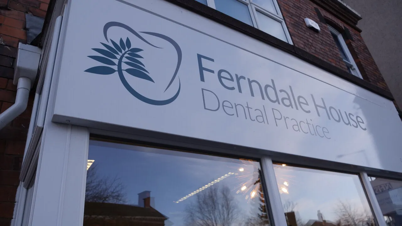 The Ferndale House Dental Practice sign above the windows of 90 Saltergate at dusk