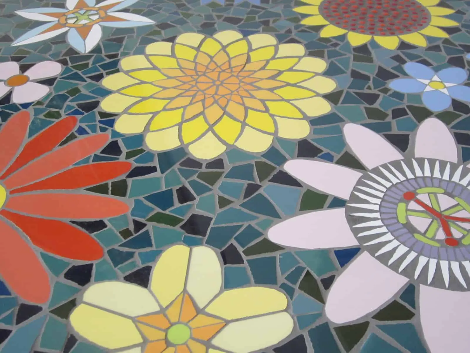 A Zantium Studios mosaic of bright flowers, from their website