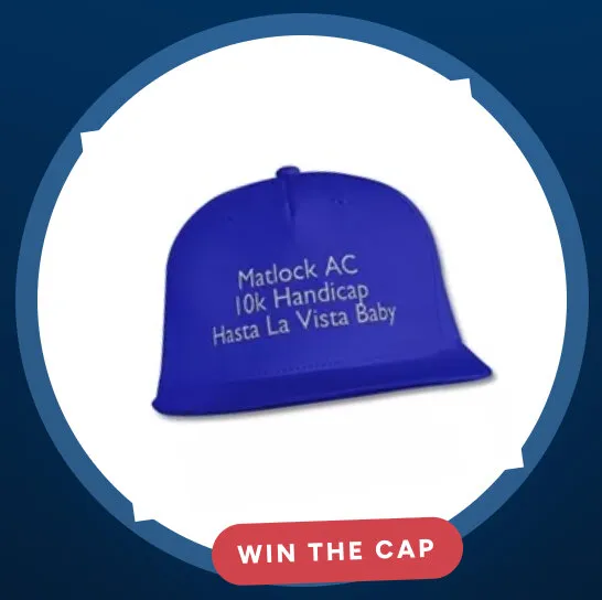 The blue Matlock AC cap, printed “10k Handicap, Hasta La Vista Baby”, in a white circle on navy with a red Win the cap badge