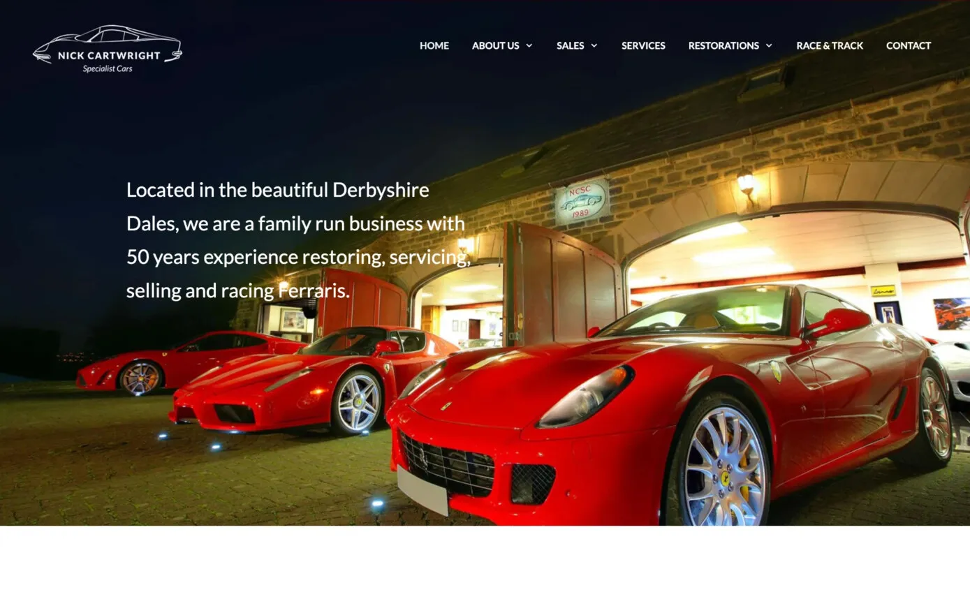 Nick Cartwright Specialist Cars homepage: three red Ferraris outside the showroom at night