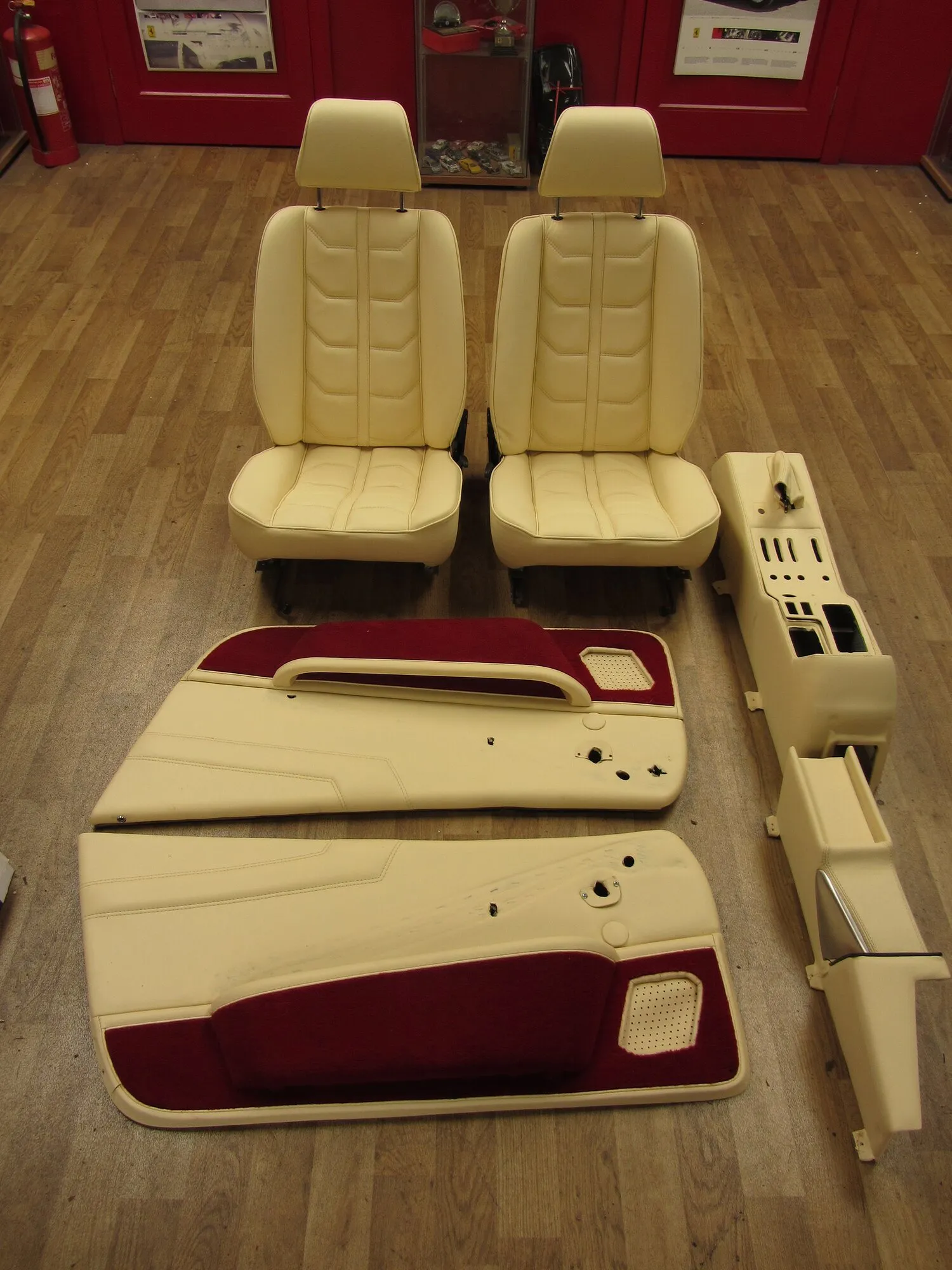 Newly re-trimmed cream leather seats, door cards and a centre console laid out on the floor