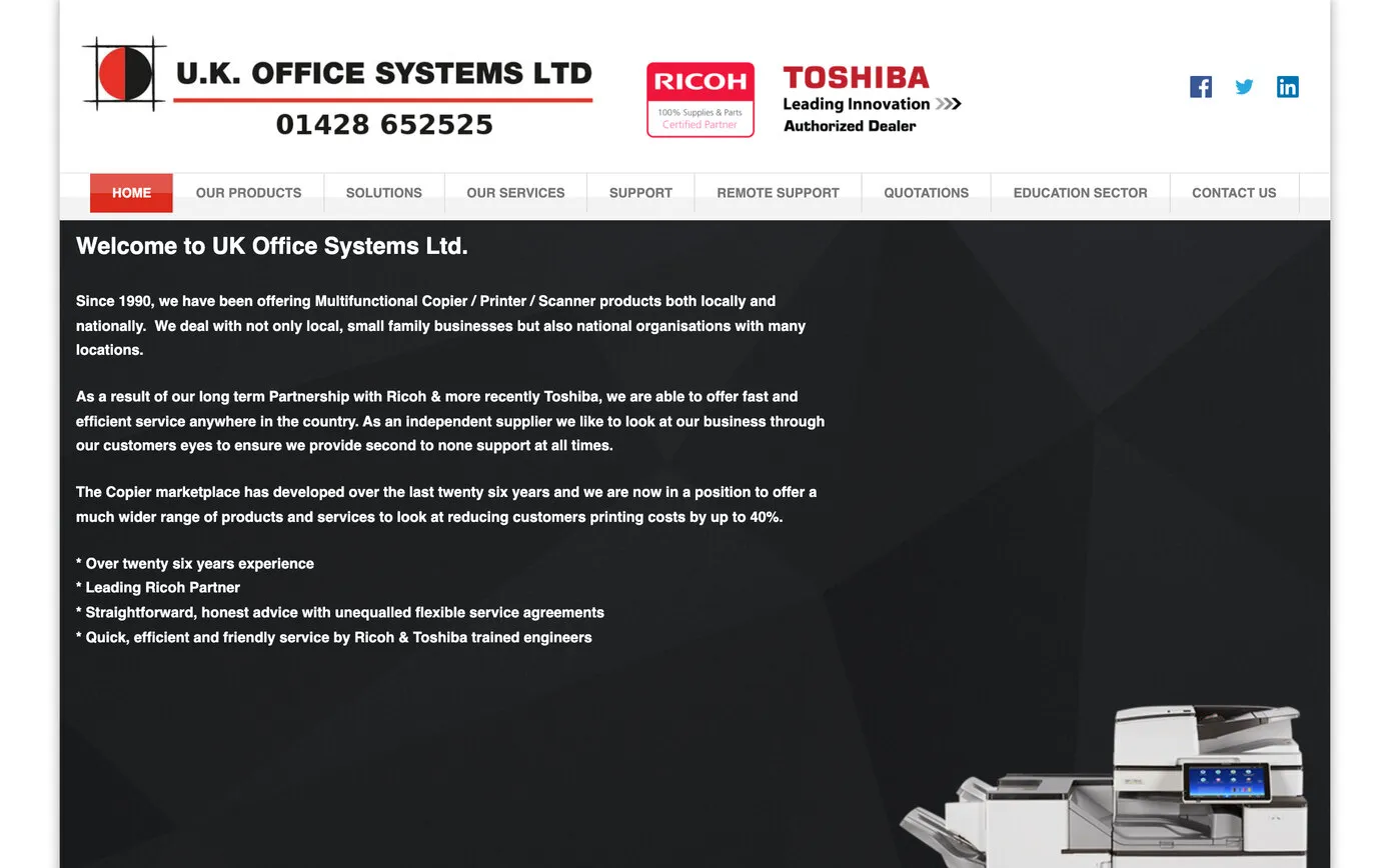 UK Office Systems’ website in March 2019: the old logo, a split circle in crop marks beside U.K. OFFICE SYSTEMS LTD and the phone number, Ricoh and Toshiba dealer badges, and white text on a dark background beginning “Welcome to UK Office Systems Ltd.”