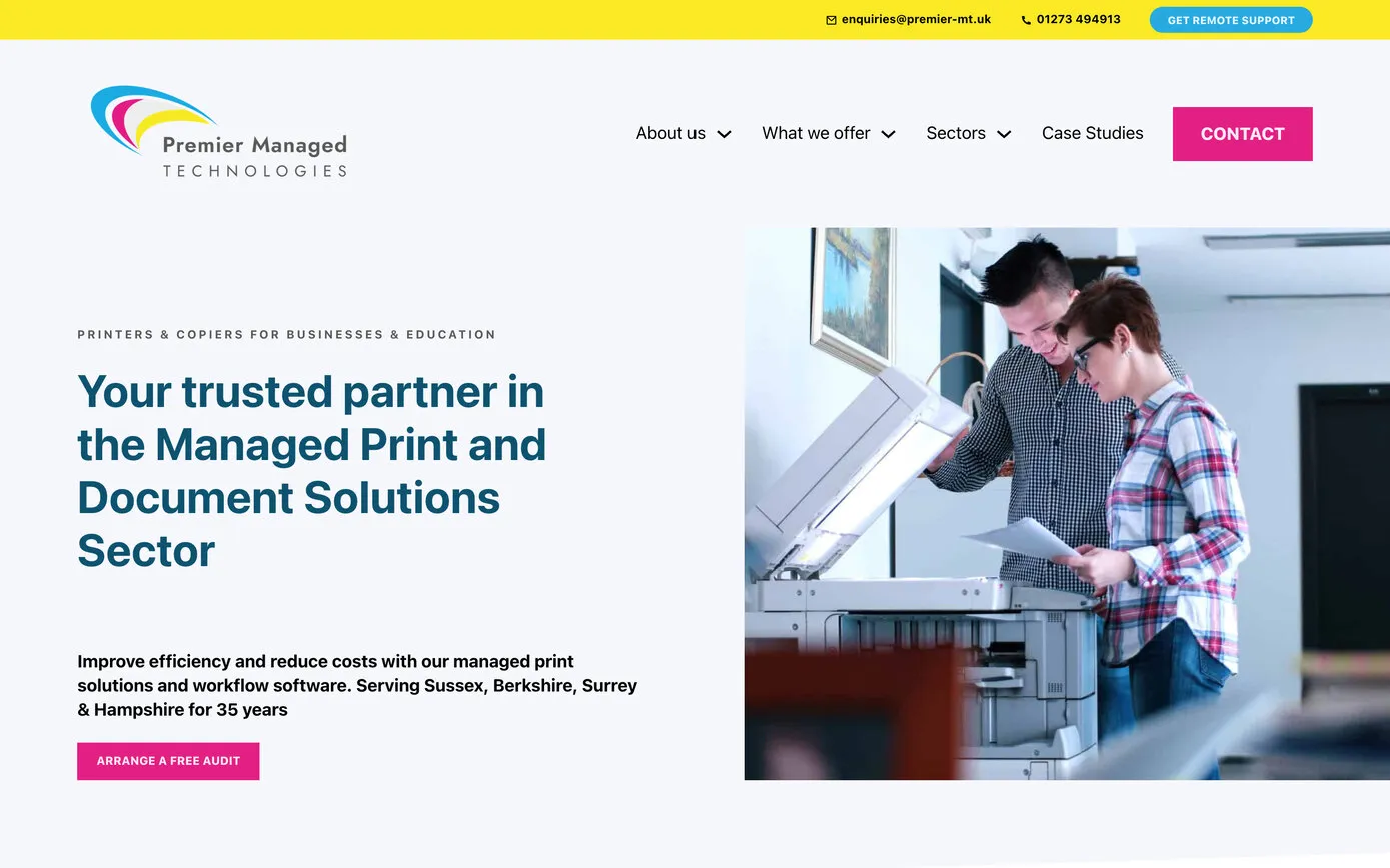 The Premier Managed Technologies home page on a desktop browser: a yellow bar along the top, the cyan, magenta and yellow logo, and “Your trusted partner in the Managed Print and Document Solutions Sector” beside a photo of two people at a copier