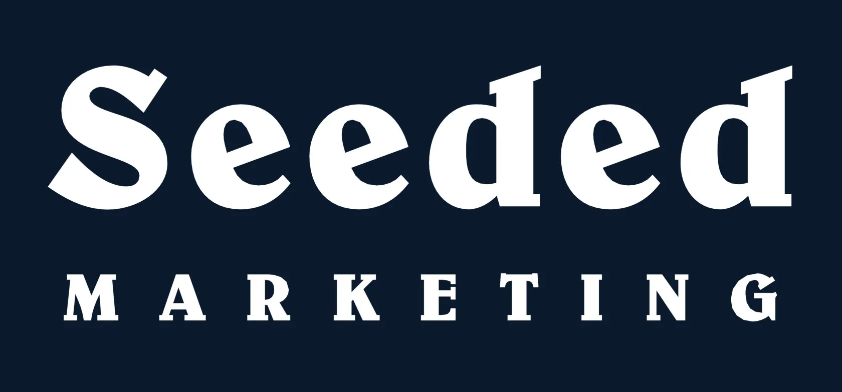 The new logo: Seeded in white with MARKETING spaced out beneath it, on ink navy
