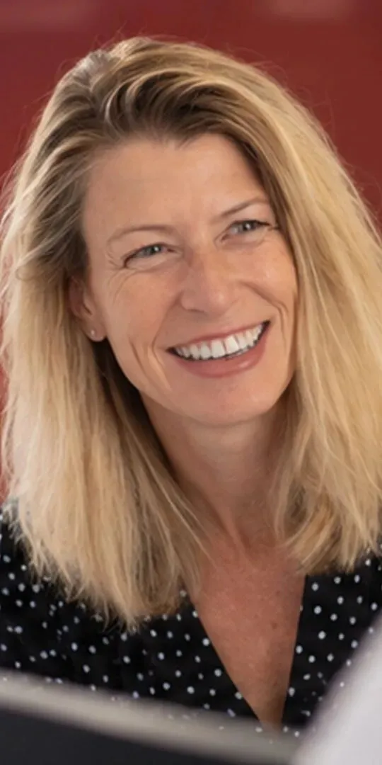 A member of the team smiling at the reception desk